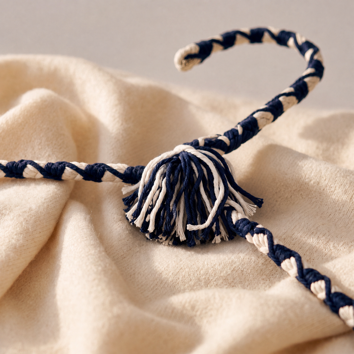 Close-up of Regal Heritage navy-and-ivory hand-knotting and two-tone tassel