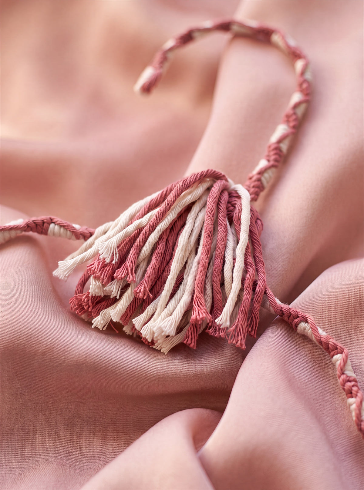 Close-up of Blush Cameo rose-and-ivory hand-knotting and two-tone tassel