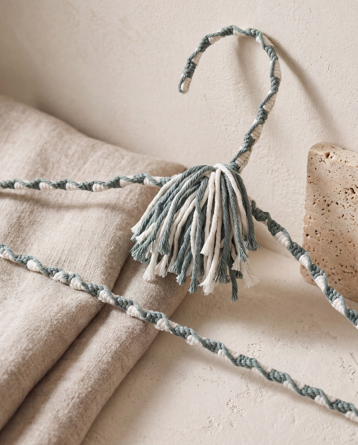 Close-up of Coastal Spa blue-green and ivory hand-knotting and two-tone tassel