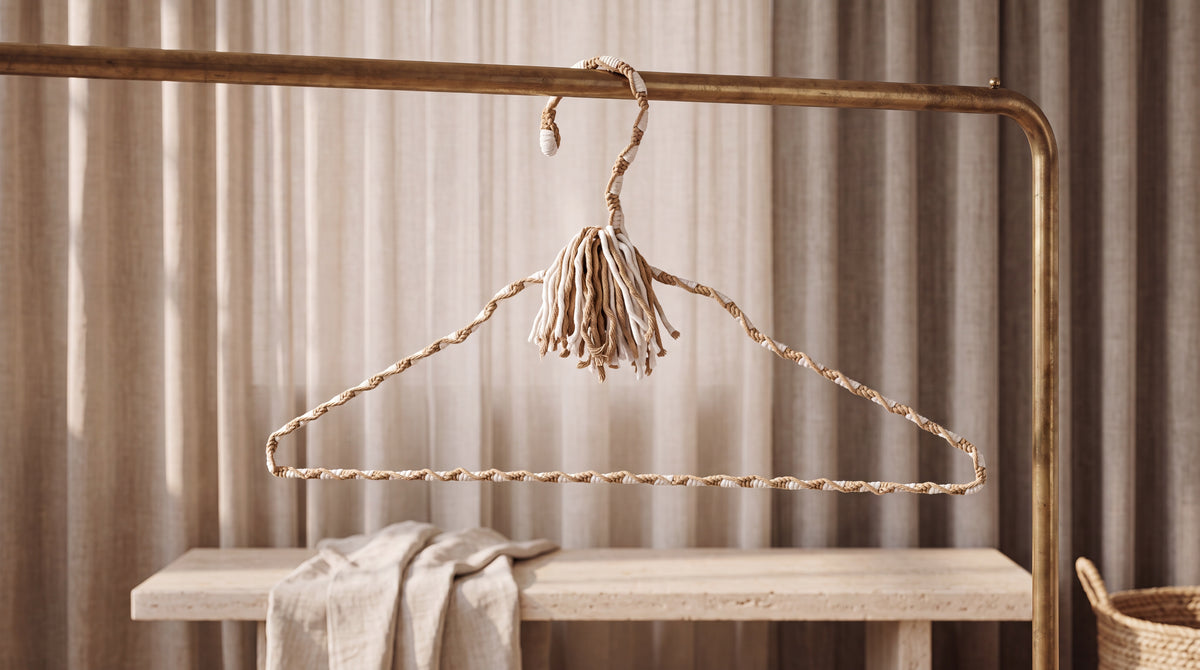 Natural Linen cream-and-sand hand-knotted cotton hanger in a warm neutral wardrobe setting
