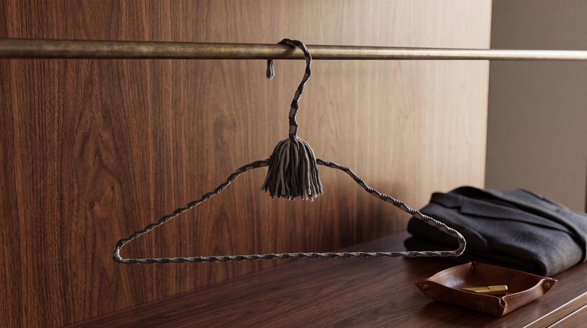 Tailored Slate charcoal-and-gray hand-knotted cotton hanger in a dark wood wardrobe
