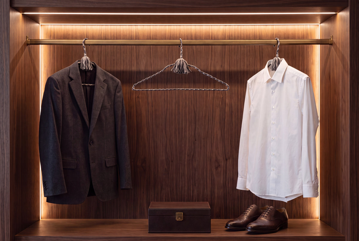 Tailored Slate hand-knotted cotton hangers displaying tailored garments in a refined wardrobe